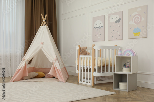 Fototapeta Naklejka Na Ścianę i Meble -  Cute baby room interior with crib and play tent
