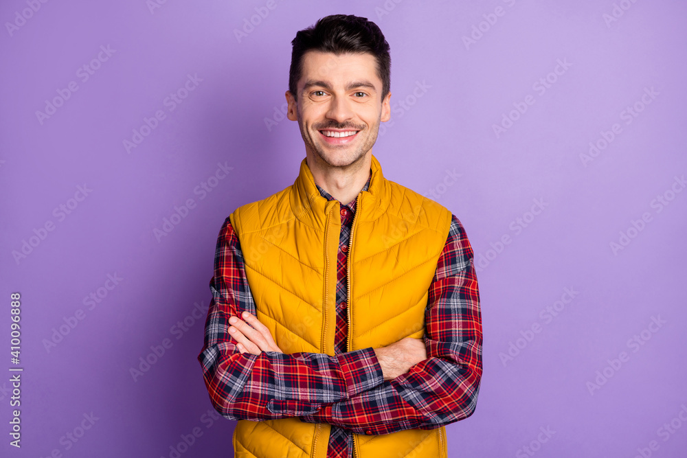 Photo of attractive handsome confident guy hipster folded hands nice smile isolated on violet color background Photo of attractive handsome confident guy hipster folded hands nice smile isolated on violet color background