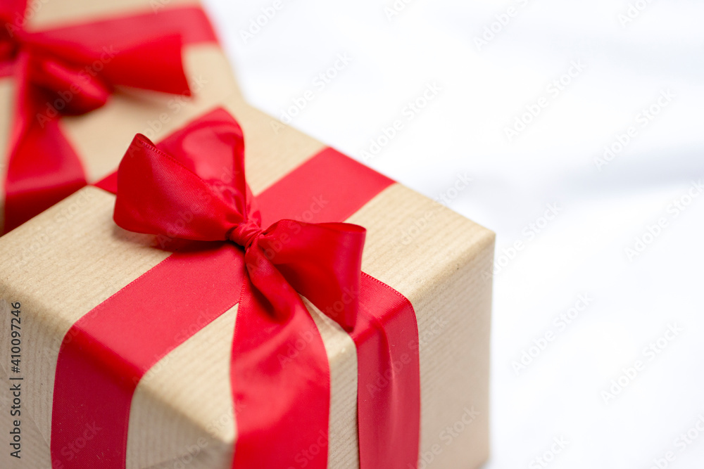 Red gift kraft box with ribbon. Valentine's Day gift in bed. Natural eco and bio gift. Sensual passion minimal gift in bed Red gift kraft box with ribbon. Valentine's Day gift in bed. Natural eco and bio gift. Sensual passion minimal gift in bed