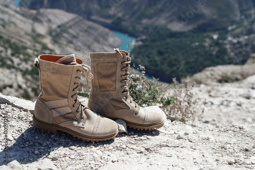 Beige army boots with laces on a nature background