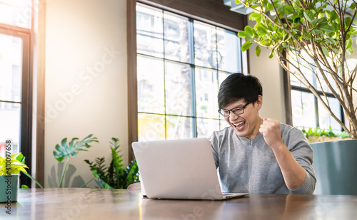 Portrait of smiling handsomel startup business asian man working in office desk using computer. Small business people employee freelance online sme marketing  telemarketing successful banner