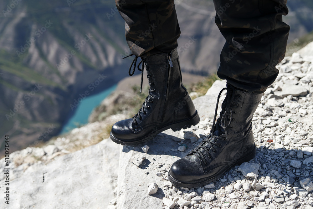 Black boots with laces for men and women and khaki pants Black boots with laces for men and women and khaki pants