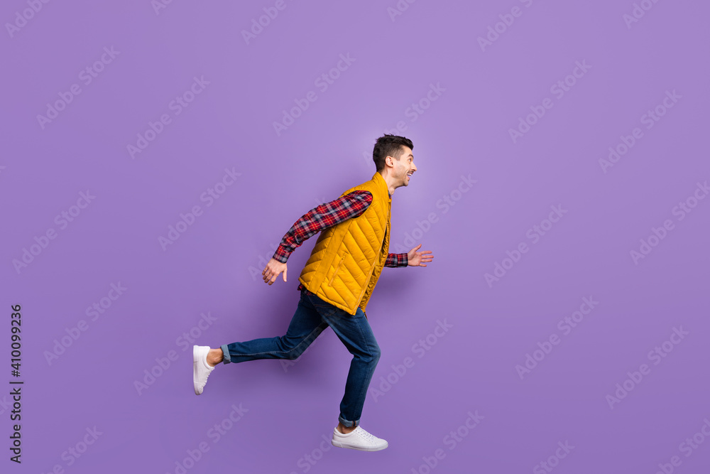 Full size profile photo of optimistic guy jump run wear shirt jeans vest isolated on violet background Full size profile photo of optimistic guy jump run wear shirt jeans vest isolated on violet background
