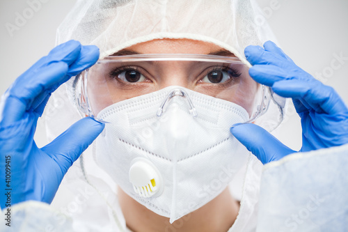 Принти на полотні Female NHS doctor,nurse or lab tech virology scientist in PPE,putting on protect