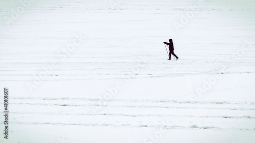 Silhouette of a lone skier on the background of a white snowy virgin land. Travel and tourism