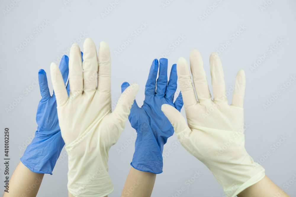 Obraz premium hands in rubber medical gloves raised up close up