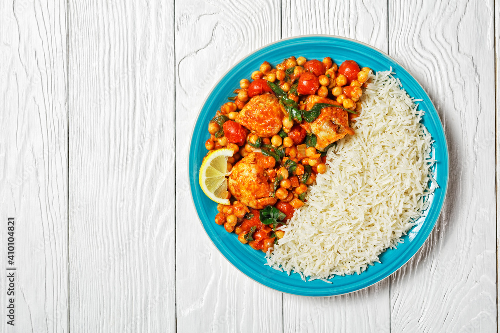 Chicken and chickpea curry on a plate, copy space