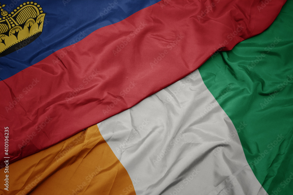 waving colorful flag of cote divoire and national flag of liechtenstein.