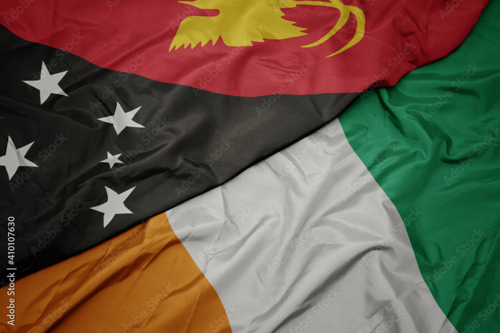 waving colorful flag of cote divoire and national flag of Papua New Guinea . waving colorful flag of cote divoire and national flag of Papua New Guinea .