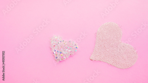 Shiny Valentines hearts from crystal bead on pink background.