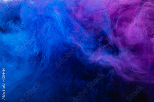 Color smoke. Neon abstract background. Ethereal mist texture. Fantasy night. Glowing ultraviolet blue purple glitter vapor wave mix on dark.