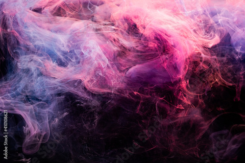 Color in water. Art background. Smoke cloud abstract texture. Enchanted air. Glowing bright pink violet paint steam wave blend on dark.