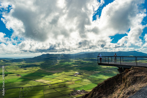 Serra do Cume viewpoint with silhouette of two people with fantastic cloudy sky, Terceira, Azores PORTUGAL photo