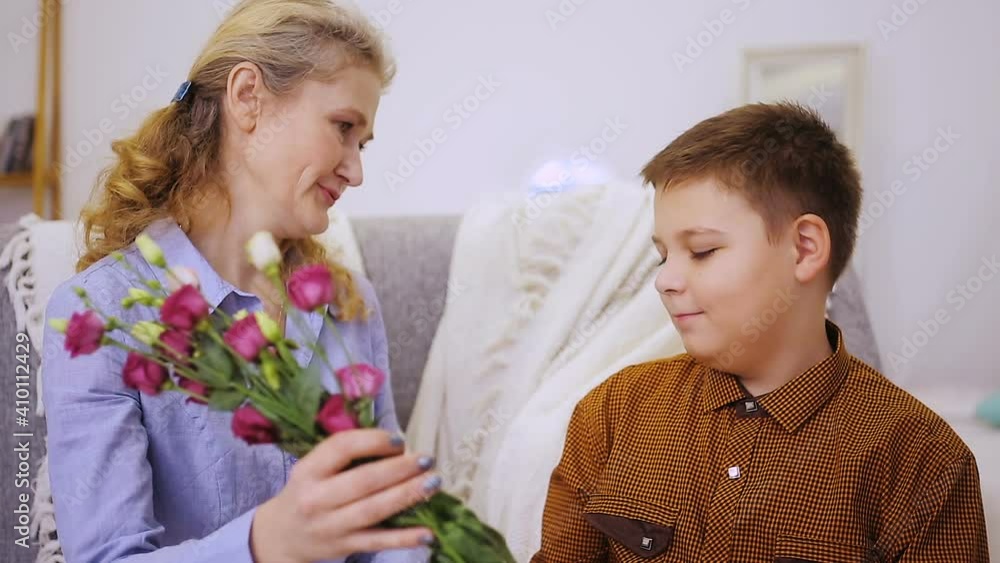 Boy gives flowers to grandmother Boy gives flowers to grandmother