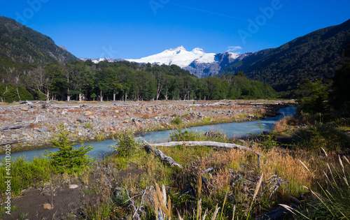 Picturesque view of river Cauquenes and snowy peak of Tronador volcano in Argentina