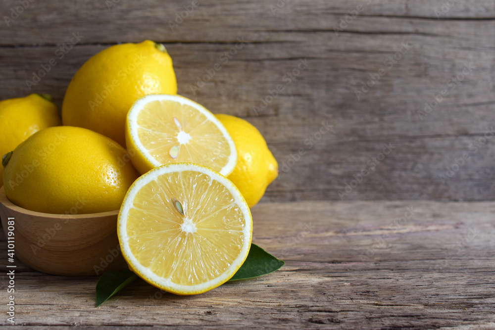 Fresh lemon and sliced on the wooden table,copy space. Fresh lemon and sliced on the wooden table,copy space.