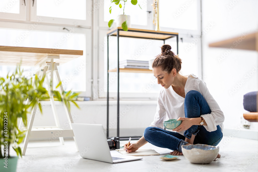 Young female freelancer working in loft office
Young female freelancer working in loft office