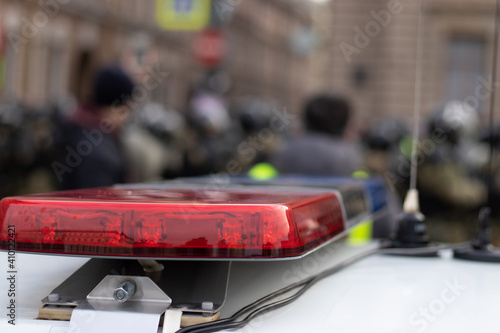 Wallpaper Mural Police alarm siren on car close-up with blurry background with riot police. Torontodigital.ca