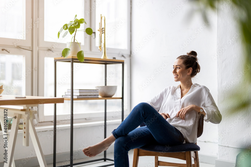 Portrait of a smiling creative woman in a modern loft space
Portrait of a smiling creative woman in a modern loft space