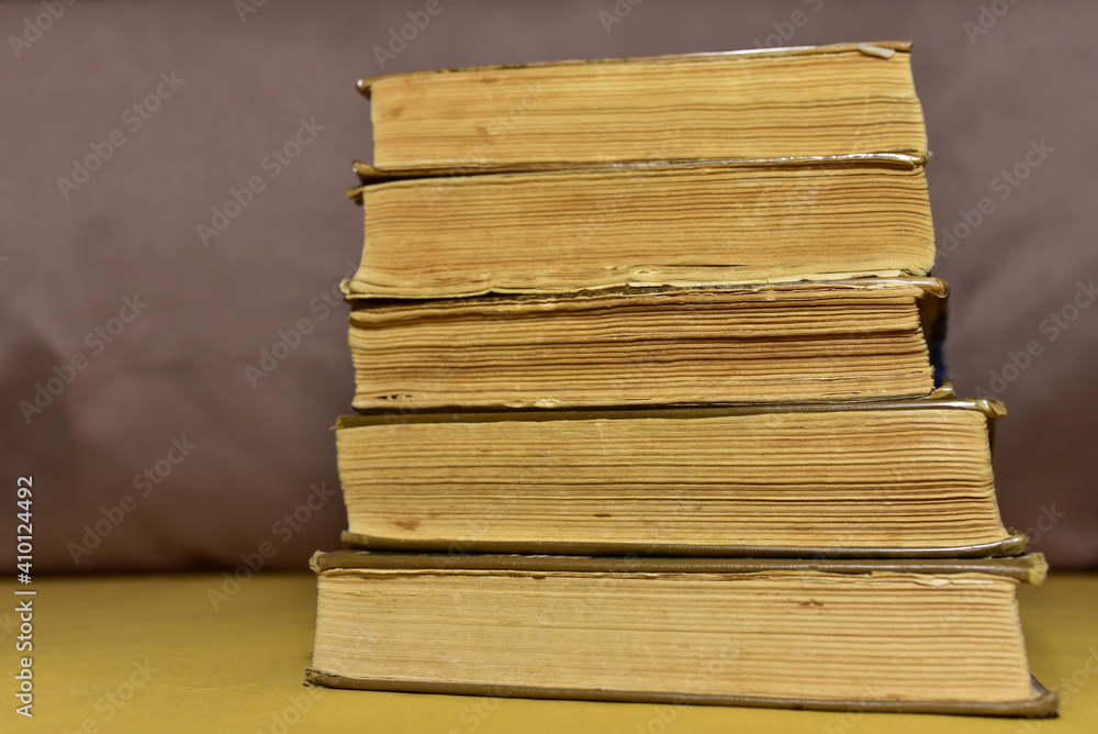 Old books on brown background. Book for reading stories. Literature and historical concept, nostalgia, old age. Retro background. Old books on brown background. Book for reading stories. Literature and historical concept, nostalgia, old age. Retro background.
