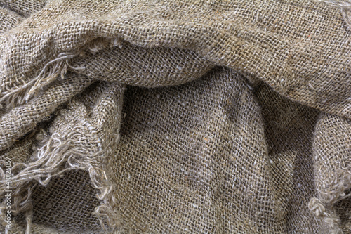 The texture of the burlap. Natural aged linen texture with creases and shadows.