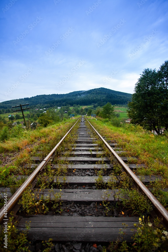 Railway in the mountains scenic views tourist route green landscape fluffy forest settlements Carpathians