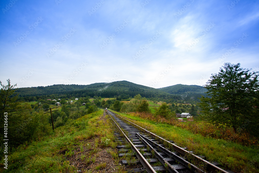 Railway in the mountains scenic views tourist route green landscape fluffy forest settlements Carpathians