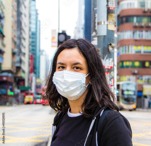 young girl with mask in hong kong street during the pandemic 