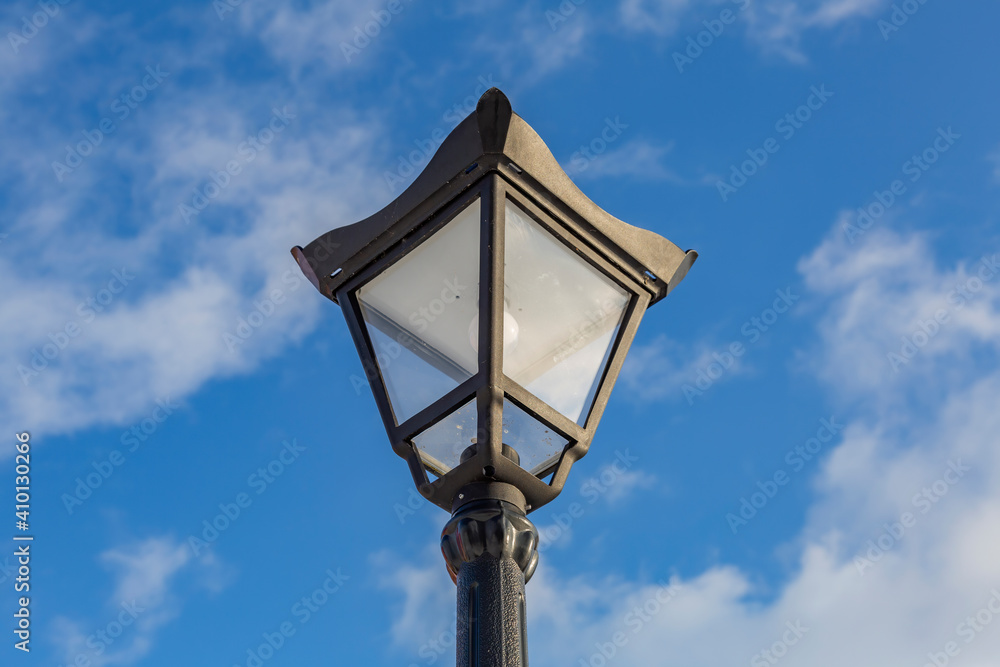 Vintage iron lantern in a public park in the daytime