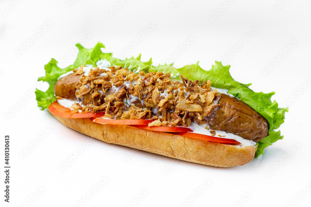 Hot dog with beef sausage, lettuce, sliced tomato, mayonnaise. Hot dog with beef sausage, lettuce, sliced tomato, mayonnaise.