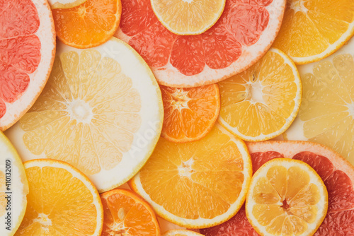 citrus fruits cut into round pieces: orange, grapefruit, lemon, tangerine.