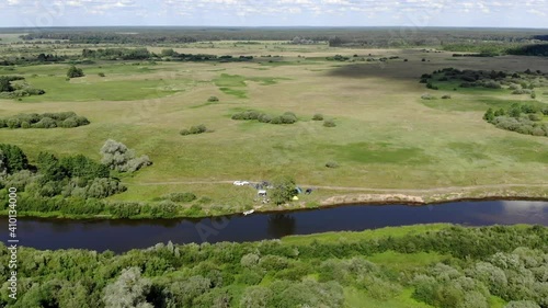 A large green field with trees in the background