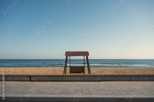 Empty wooden bench on the beach with tropical sea view