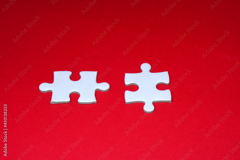 Connecting jigsaw puzzle on red Background with Copy Space, Business solutions, success and strategy concept Connecting jigsaw puzzle on red Background with Copy Space, Business solutions, success and strategy concept