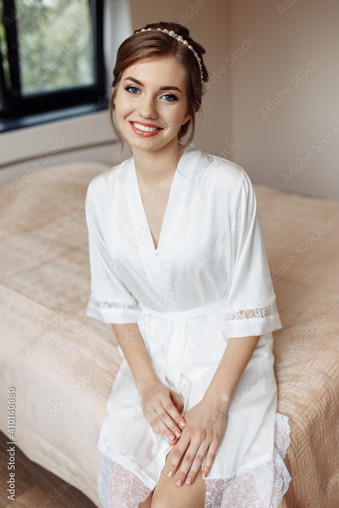 lovely bride in a wedding robe is going to the wedding. a hoop on the bride's head. the bride is going home. happy girl. bridal bouquet of peonies