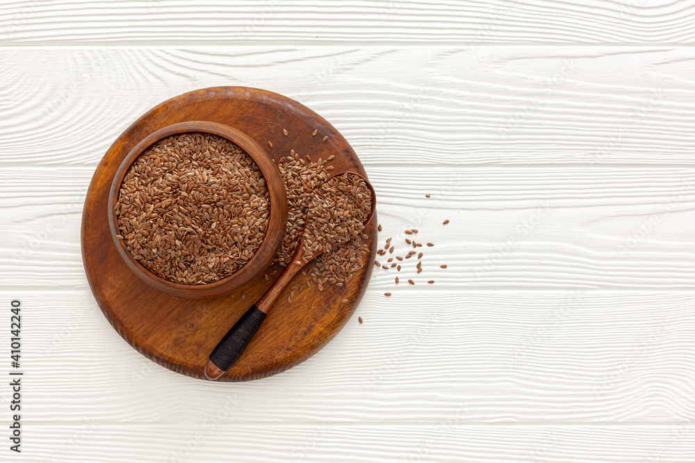 Flax seeds in a spoon and bowl with a bottle of flaxseed oil Flax seeds in a spoon and bowl with a bottle of flaxseed oil