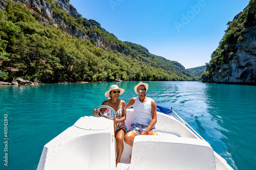 cliffy rocks of Verdon Gorge at lake of Sainte Croix, Provence, France, Provence Alpes Cote d Azur, blue green lake with boats in France Provence. Europe couple men woman mid age on vacation Provence  photo