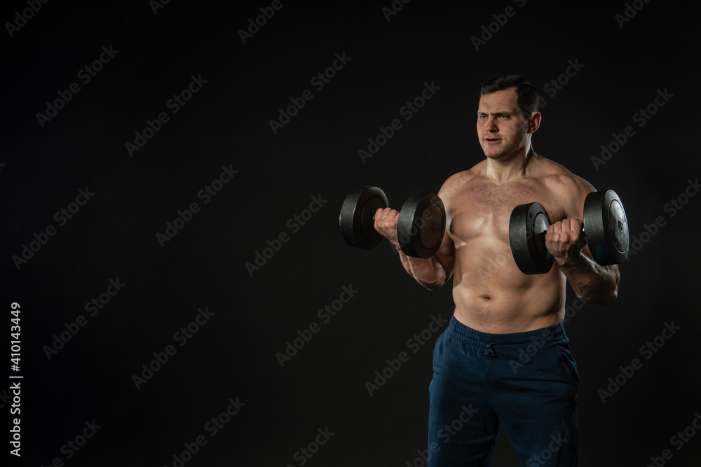 Man strains muscles with dumbbells pumps bicep bare torso Young male business handsome, attractive strong fitness. Seller fashion smile background black bodybuilder