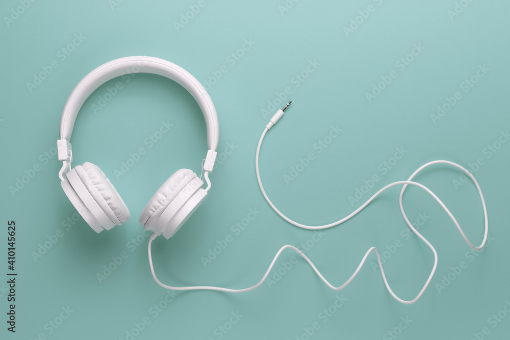 Modern white headphone on cyan background. Music concept. Modern white headphone on cyan background. Music concept.