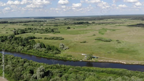 A large green field with trees in the background