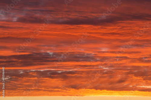 Sunrise, sunset orange yellow pink red sky with clouds background texture © Viktor Iden