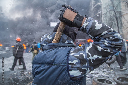 Fotografie Man with a truncheon during the riots in the city of Kyiv, Ukraine