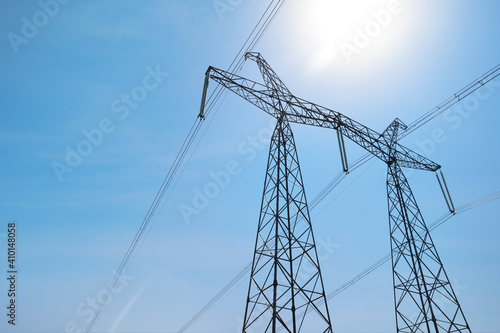 Wallpaper Mural High voltage tower with electricity transmission power lines against blue sky, low angle view Torontodigital.ca