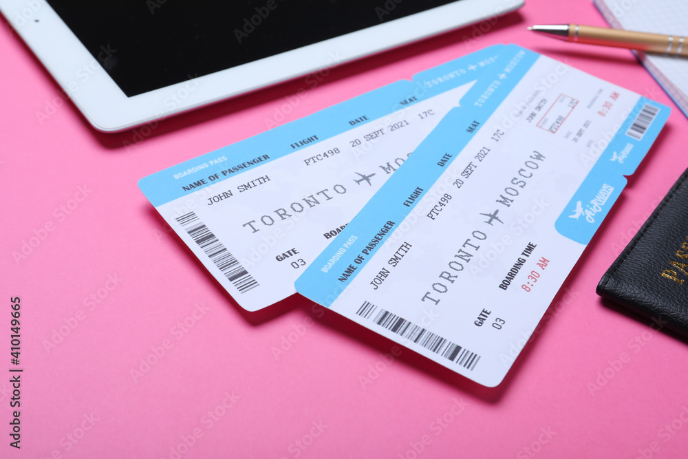 Tickets, passport and tablet on pink background. Travel agency concept Tickets, passport and tablet on pink background. Travel agency concept