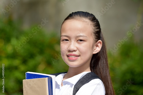 Young Diverse Girl Student Portrait With School Books