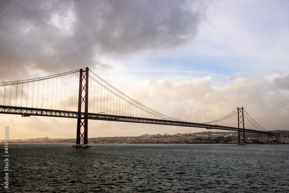 The 25 April bridge (Ponte 25 de Abril) - famous bridge in Lisbon and among of the longest ones in Europe. The 25 April bridge (Ponte 25 de Abril) - famous bridge in Lisbon and among of the longest ones in Europe.