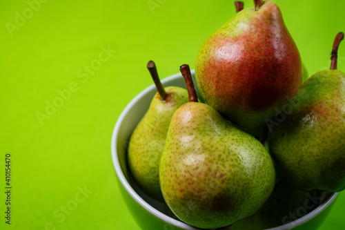 bright and fresh pears on green background