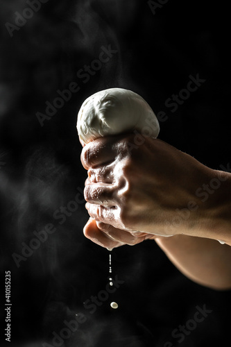 Bild auf Leinwand Italian hard cheese silano or caciocavallo in cheesemaker hands