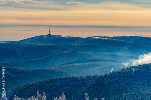 Winter fir and pine forest covered with snow after strong snowfall in praded jeseniky czech photo