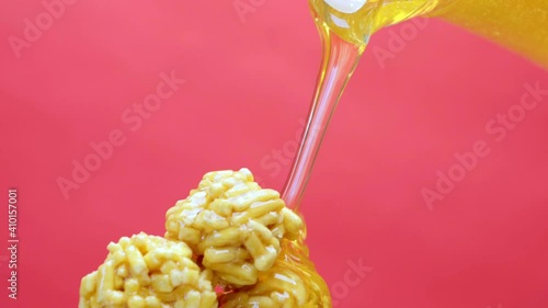 Pouring fresh honey on Tatar sweets chack-chack on pink photo